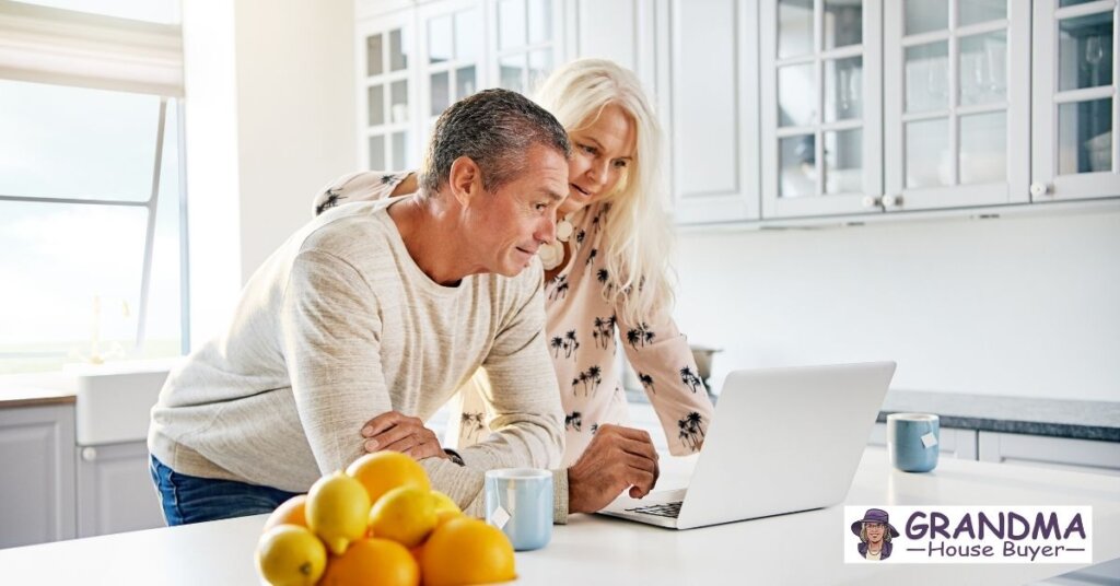 Middle-aged couple reviews mortgage options on a laptop in their Texas kitchen while exploring how to sell their upside-down house