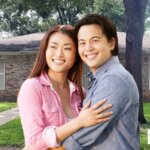 Smiling couple in front of their Texas home after avoiding foreclosure with help from Grandma House Buyer