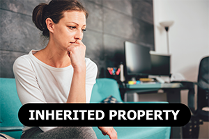 concerned woman sitting on couch thinking about selling her inherited property for cash in Bellville